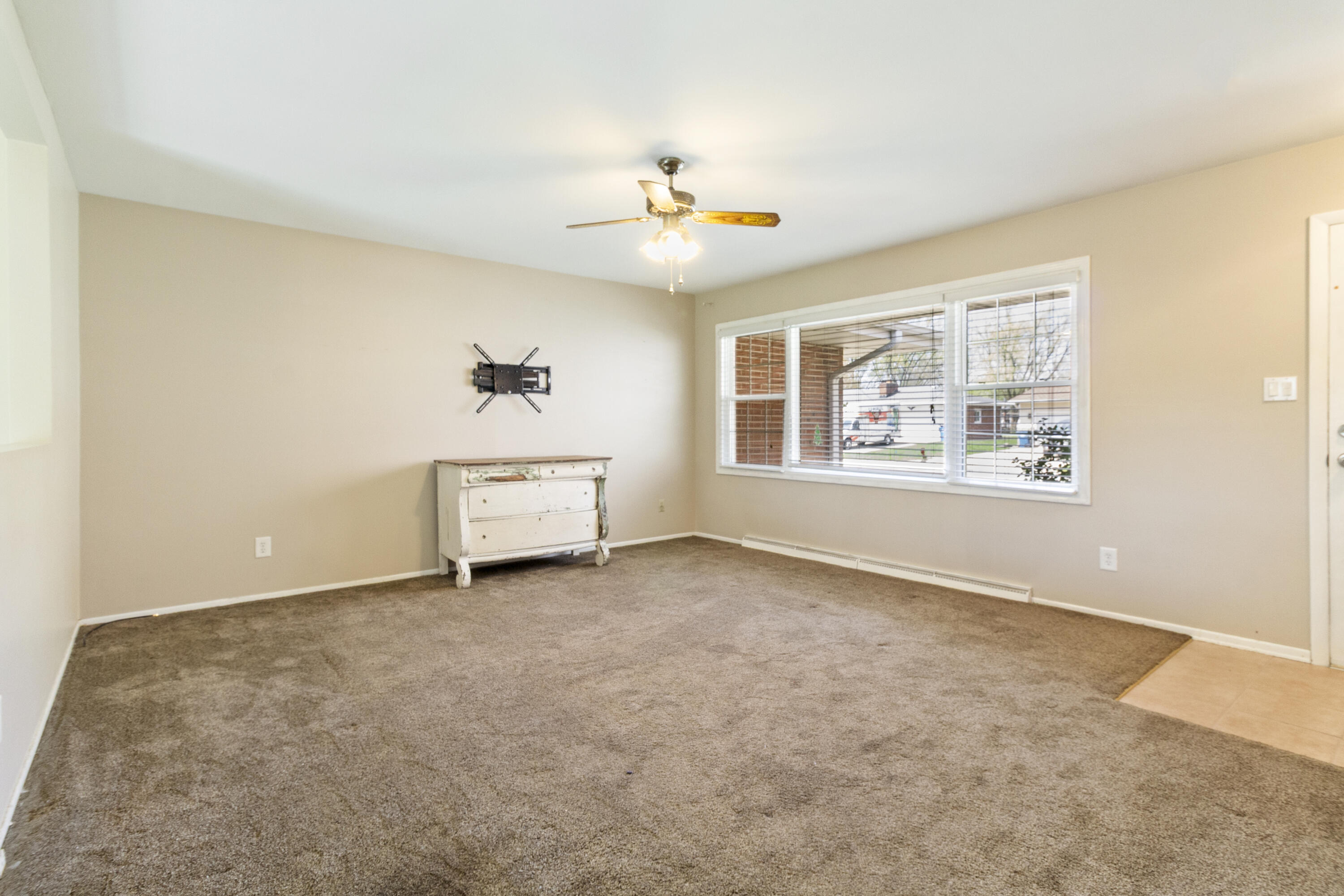 407 East Elizabeth Drive Crown Point, IN 46307 - Photo 2 of 24 an empty room with windows and ceiling fan