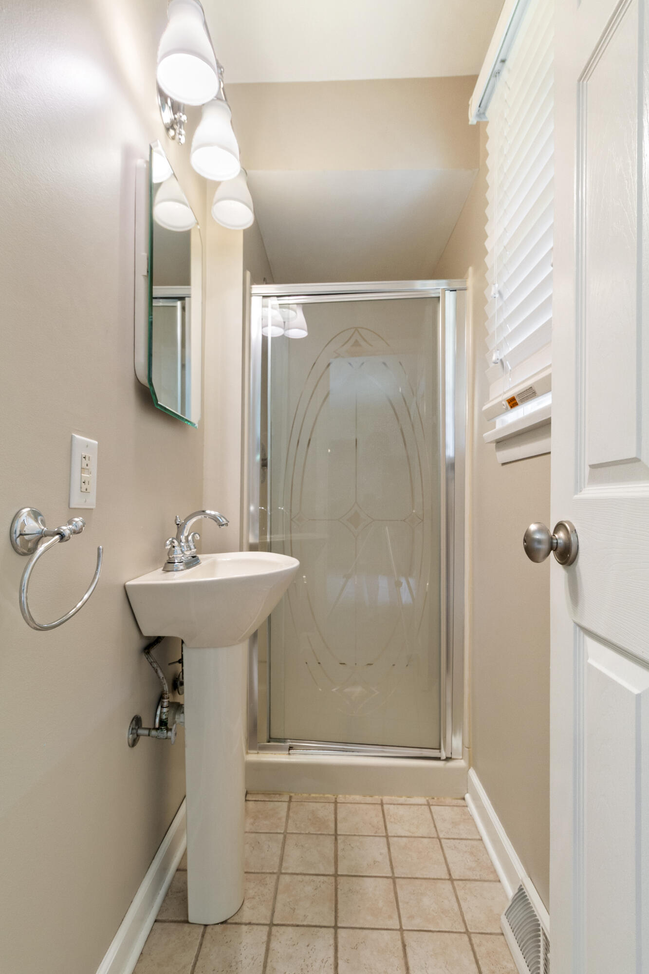 407 East Elizabeth Drive Crown Point, IN 46307 - Photo 7 of 24 a bathroom with a sink a mirror a toilet and shower