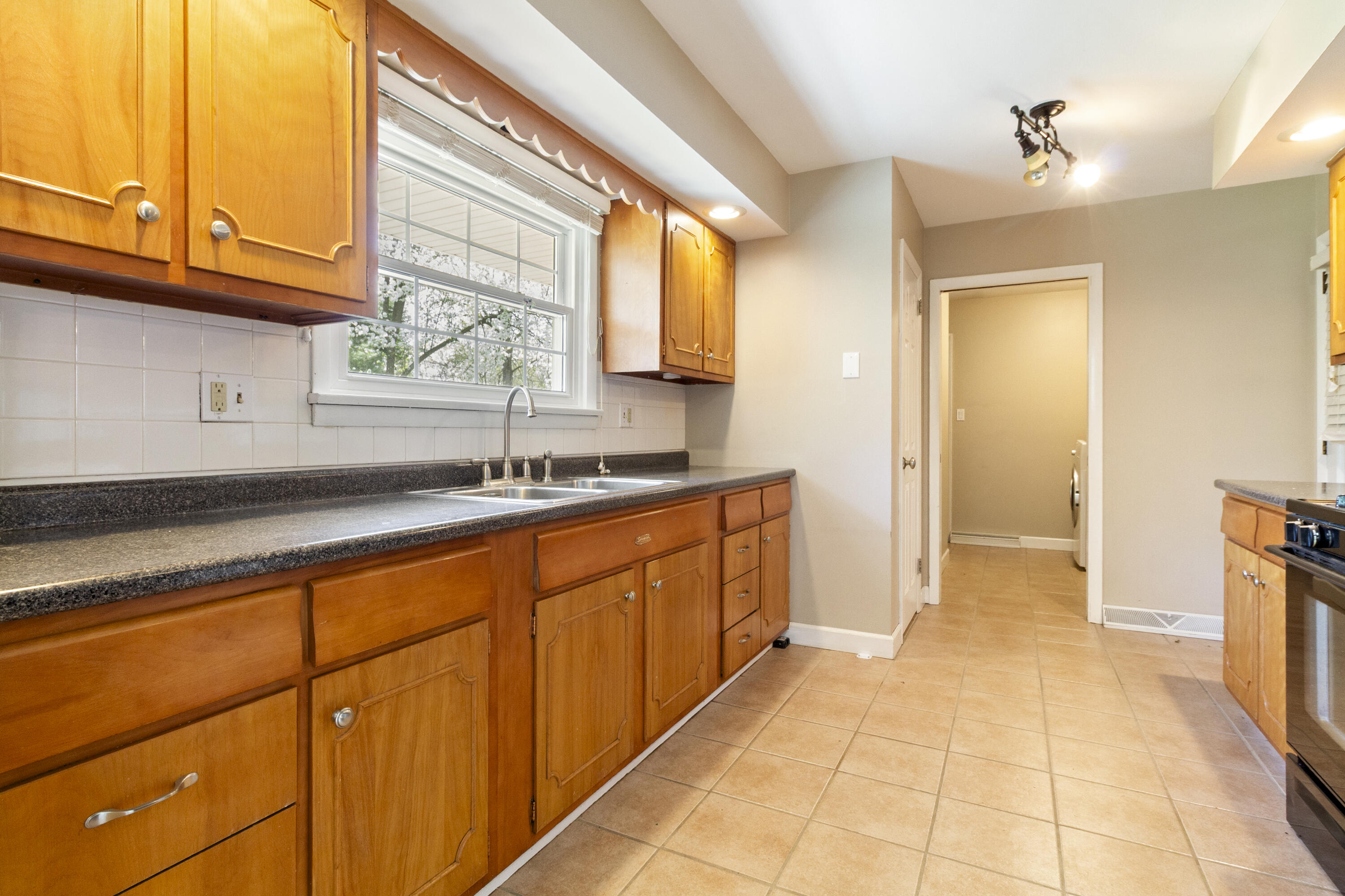 407 East Elizabeth Drive Crown Point, IN 46307 - Photo 8 of 24 a kitchen with granite countertop a sink and a stove