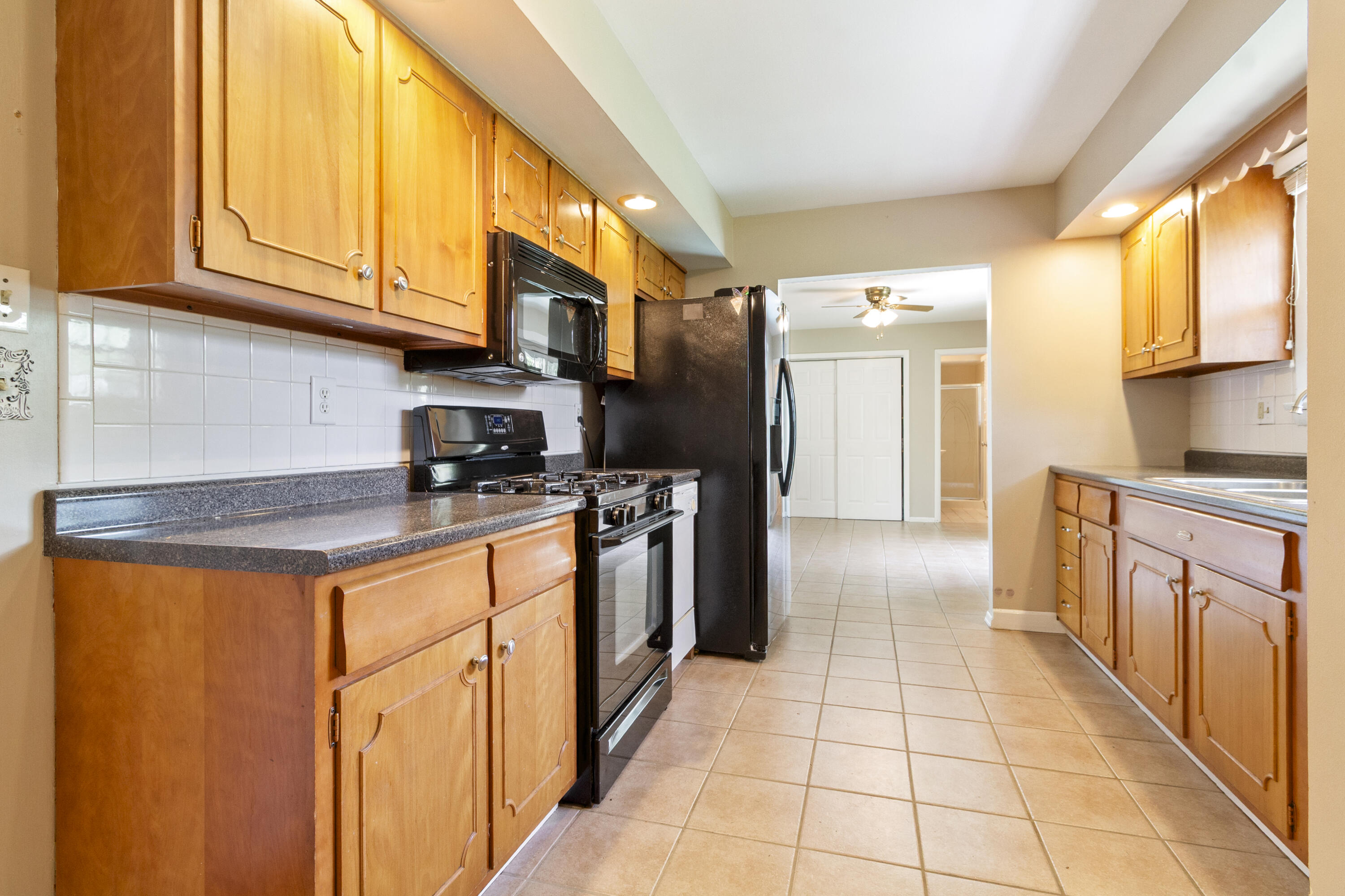 407 East Elizabeth Drive Crown Point, IN 46307 - Photo 9 of 24 a kitchen with stainless steel appliances granite countertop a refrigerator and a stove top oven