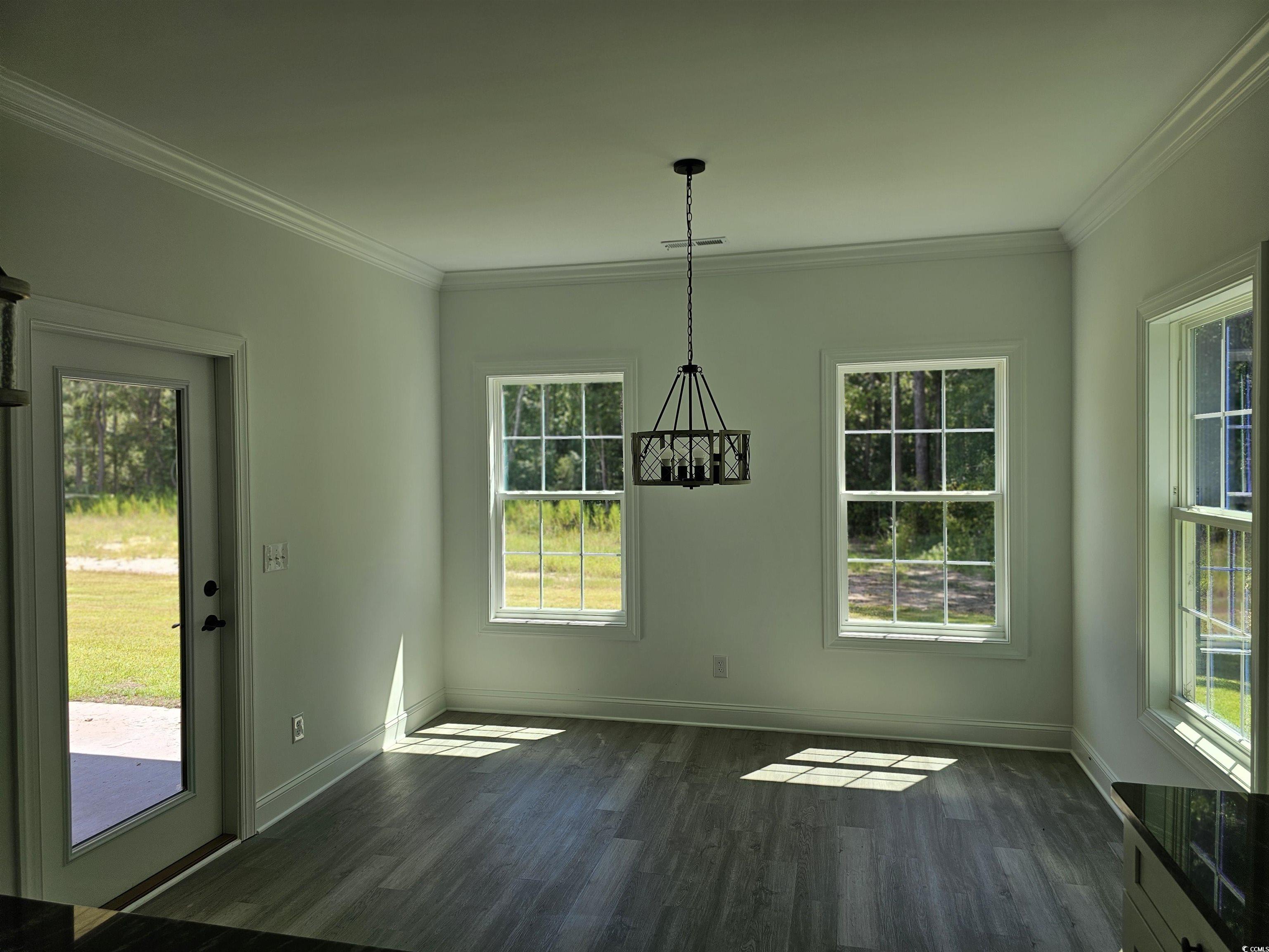 3808 Kelly Road Conway, SC 29526 - Photo 8 of 21 Unfurnished dining area with crown molding, dark h