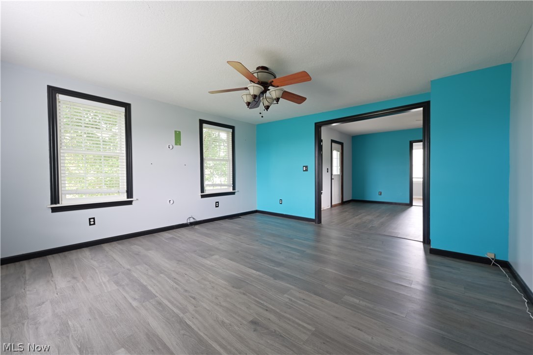 19105 Whitehead Road Lagrange, OH 44050 - Photo 10 of 37 Unfurnished room featuring a textured ceiling, ceiling fan, and hardwood / wood-style floors