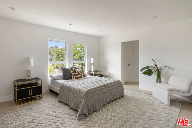 a bathroom with a granite countertop sink toilet a mirror a vanity and a shower