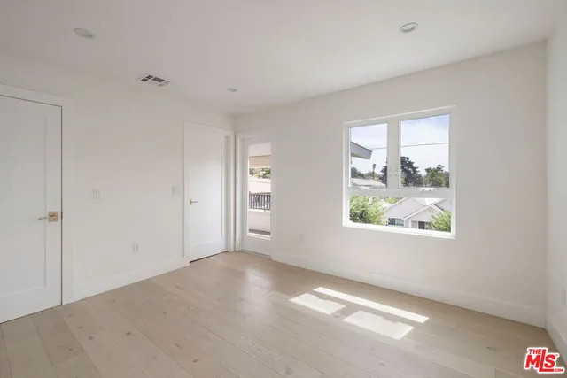 a view of roof deck with wooden floor and fence