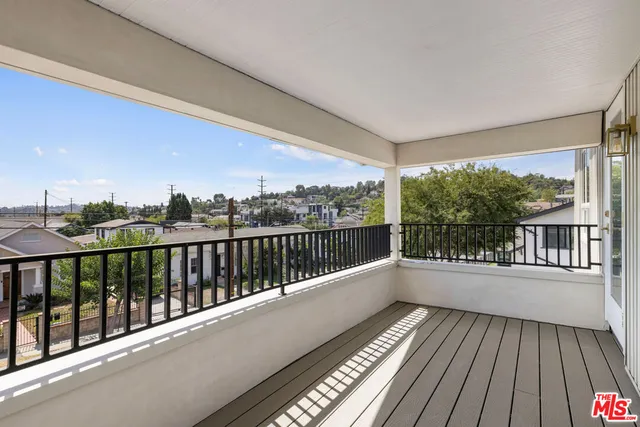 a view of a house with a yard covered in snow