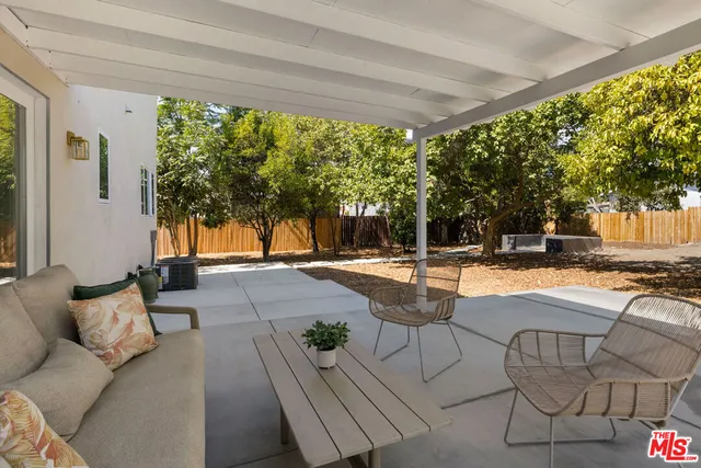 a view of a house with backyard and a tree