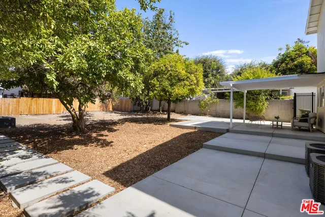 a backyard of a house with yard and outdoor seating