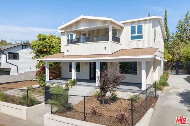 a front view of a house with porch and garden