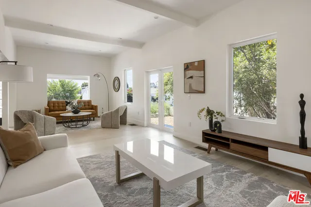 a dining room with chandelier and wooden floor