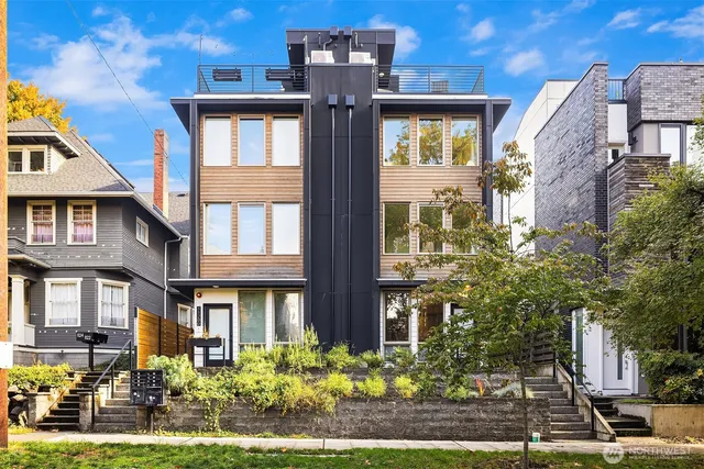 a front view of a residential apartment building with a yard