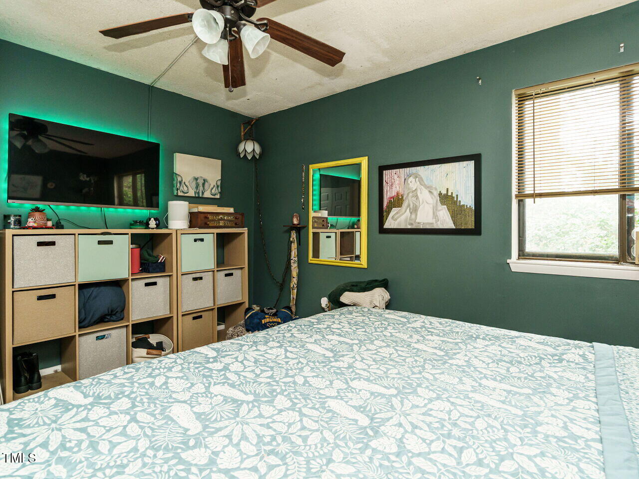 713 Godwin Court Raleigh, NC 27606 - Photo 19 of 29 a bedroom with a bed and a flat screen tv