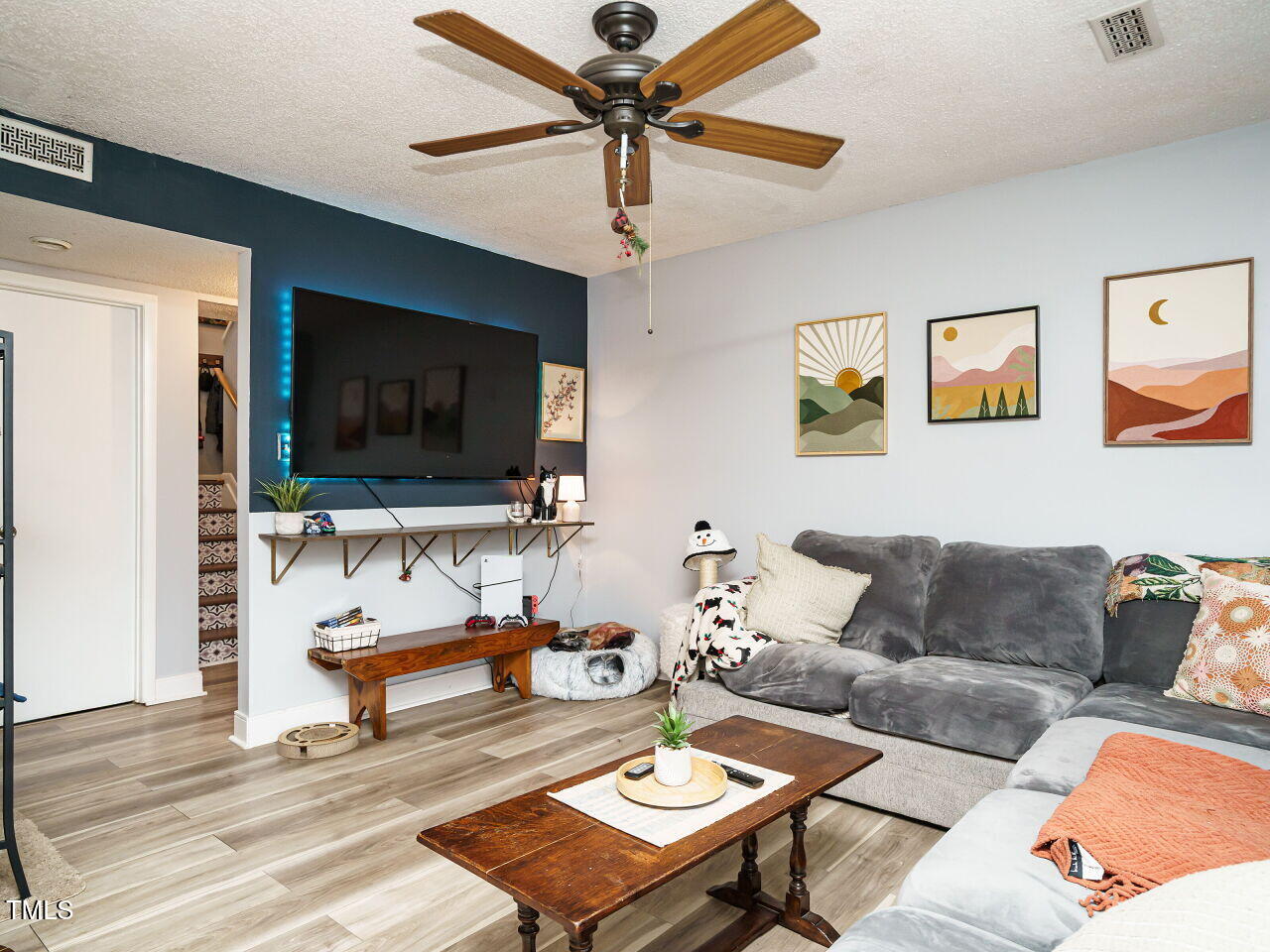713 Godwin Court Raleigh, NC 27606 - Photo 3 of 29 a living room with furniture and a flat screen tv