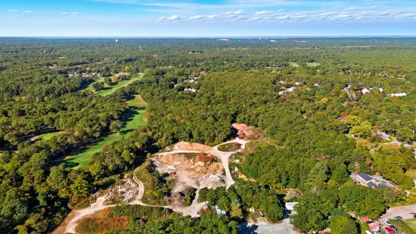 an aerial view of residential houses with outdoor space