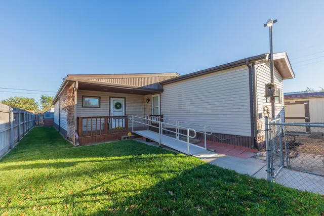 a view of a house with a yard and deck
