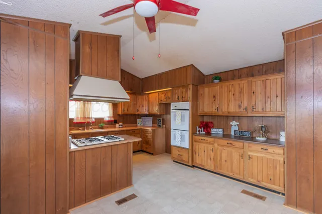 a kitchen with stainless steel appliances a stove a refrigerator and cabinets