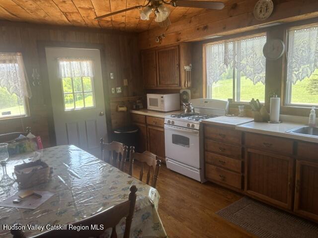 119 South Mountain Road Gilboa, NY 12076 - Photo 11 of 24 a kitchen with a stove a sink and a refrigerator