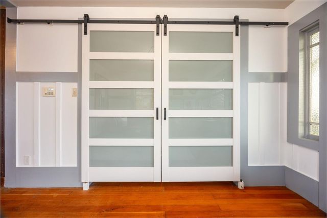 a kitchen with a white cabinets and chairs