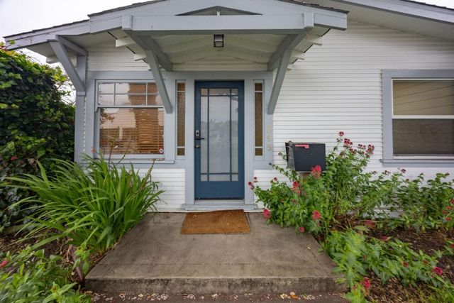 a front view of a house with garden