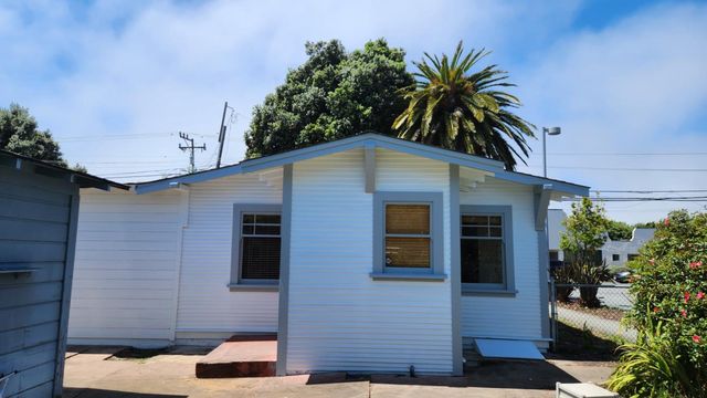a house that has a palm tree in front of it