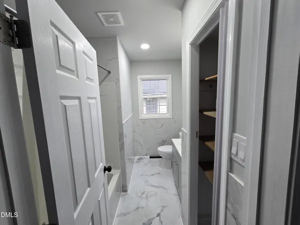 a view of a bathroom from a hallway