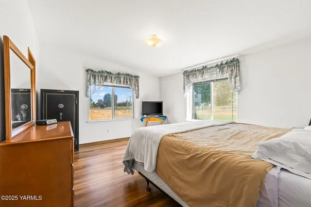 a bed sitting in a bedroom next to a window