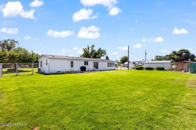 a swimming pool with yard and outdoor seating