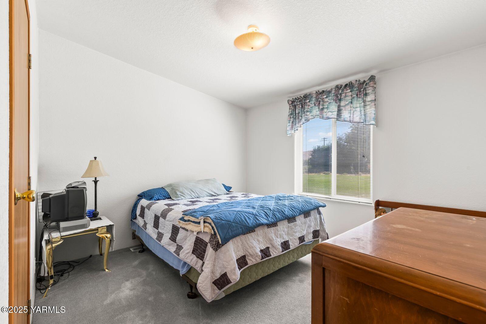 7907 Ahtanum Road Yakima, WA 98903 - Photo 17 of 21 a bedroom with a bed and window