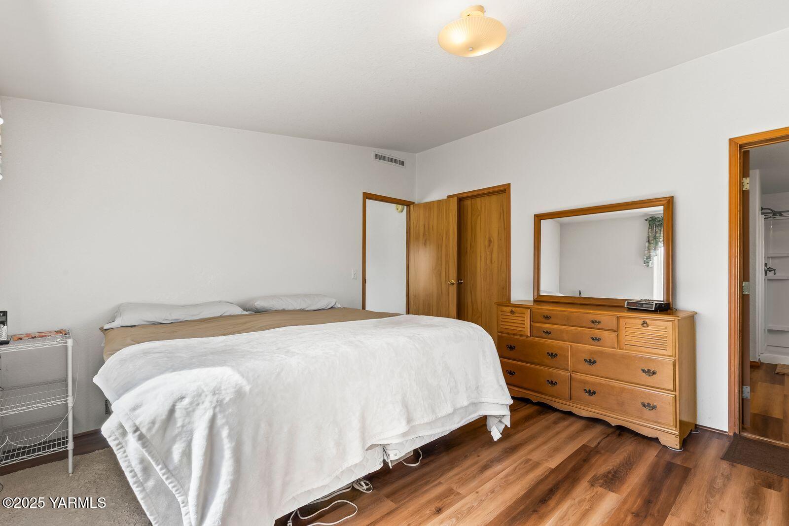 7907 Ahtanum Road Yakima, WA 98903 - Photo 19 of 21 a bedroom with a bed and a flat tv screen on dresser
