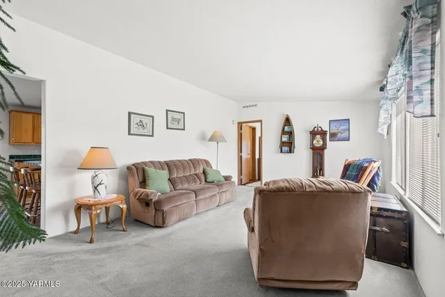 a living room with furniture a couch and a flat screen tv