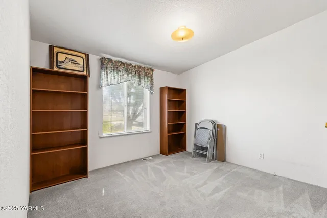 a view of a livingroom with furniture and closet