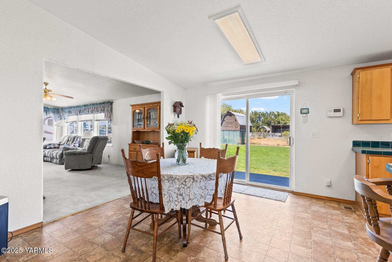 7907 Ahtanum Road Yakima, WA 98903 - Photo 10 of 21 a dining room with furniture and a floor to ceiling window