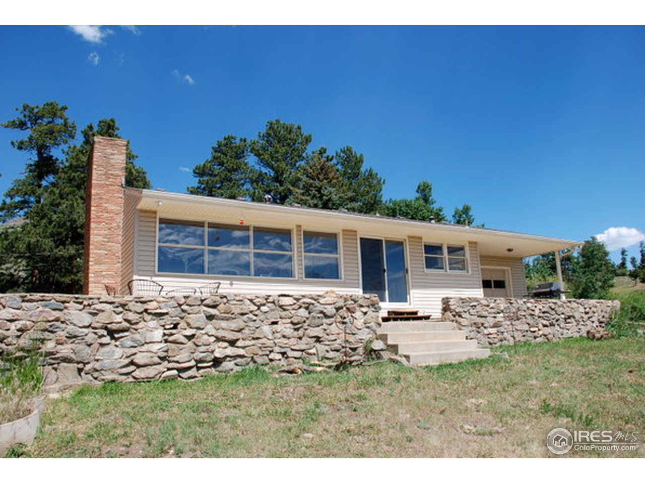 58 Old Post Office Road Boulder, CO 80302 - Photo 1 of 16 a front view of a house with a garden