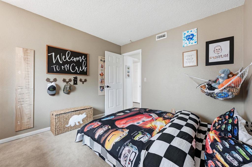 270 Chestnut Way Oceanside, CA 92057 - Photo 25 of 43 a bedroom with a bed and a painting on the wall