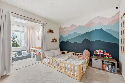 a bedroom with furniture and a baby crib