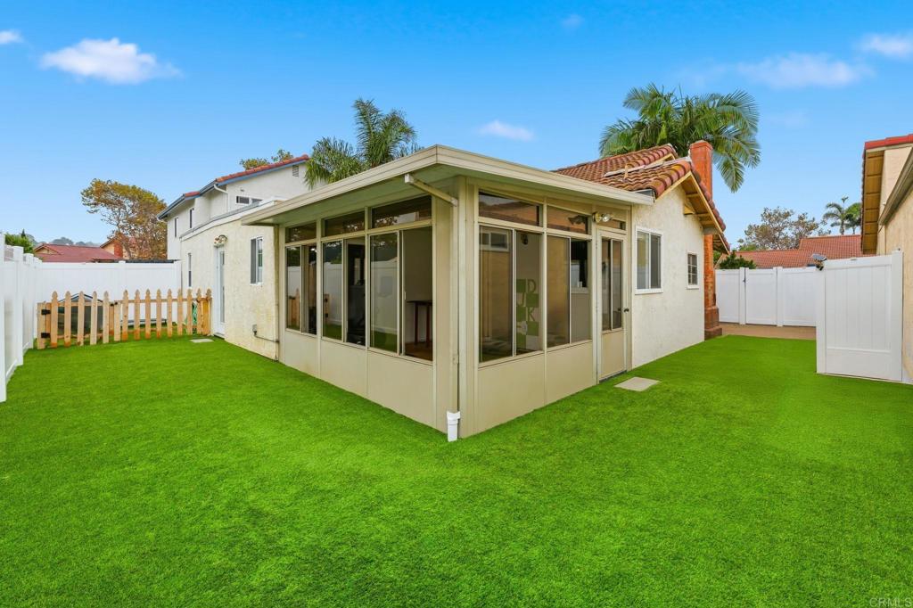 270 Chestnut Way Oceanside, CA 92057 - Photo 28 of 43 a view of a white house with a big yard and large trees