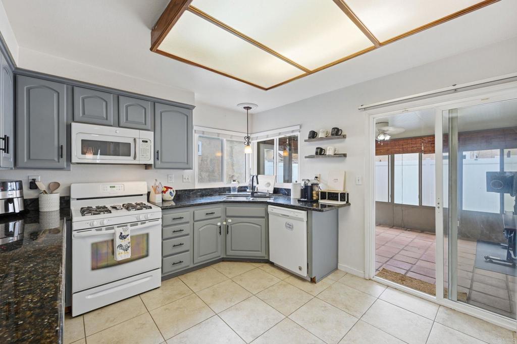 270 Chestnut Way Oceanside, CA 92057 - Photo 4 of 43 a kitchen with stainless steel appliances granite countertop a stove top oven a sink dishwasher and a refrigerator
