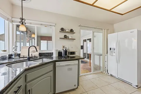 a kitchen with white cabinets and appliances