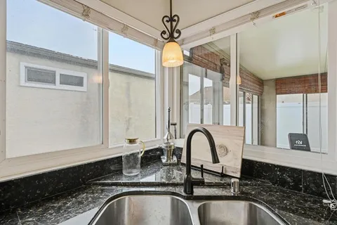 a close view of a sink a faucet and a window