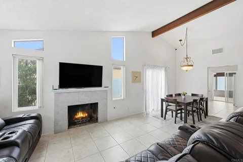 a living room with furniture fireplace and window