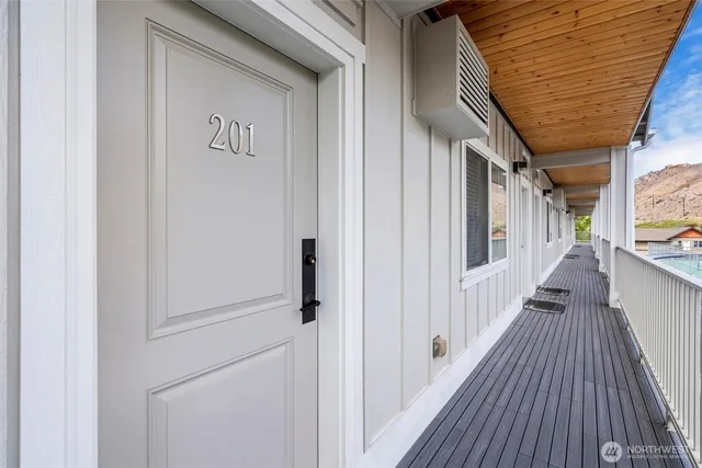 a living room with furniture a large window and a flat screen tv