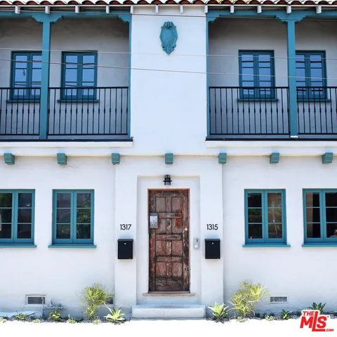 a front view of a house with large windows