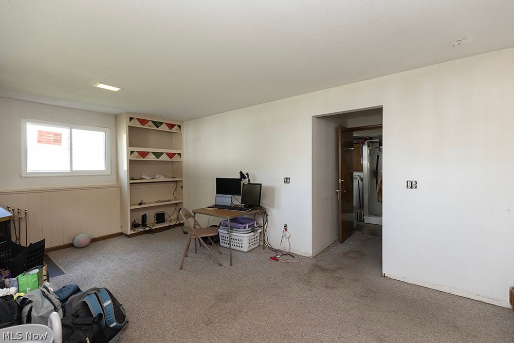 762 Abbe Road North Elyria, OH 44035 - Photo 22 of 30 Carpeted interior space featuring white walls and a built-in shelving unit