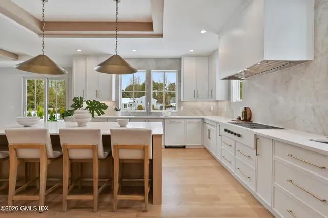 a spacious bathroom with a double vanity sink a large mirror and a bathtub