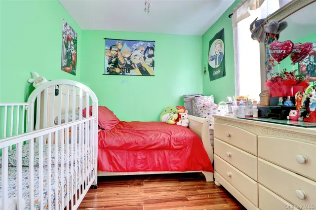 a bedroom with furniture and a baby crib