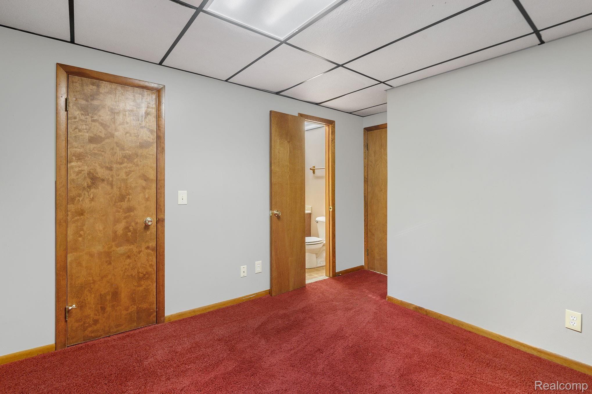2469 Academy Road Holly, MI 48442 - Photo 41 of 44 Basement Bedroom 2, Closet, Entrance to Two Entry Full Bathroom, and Bedroom Door
