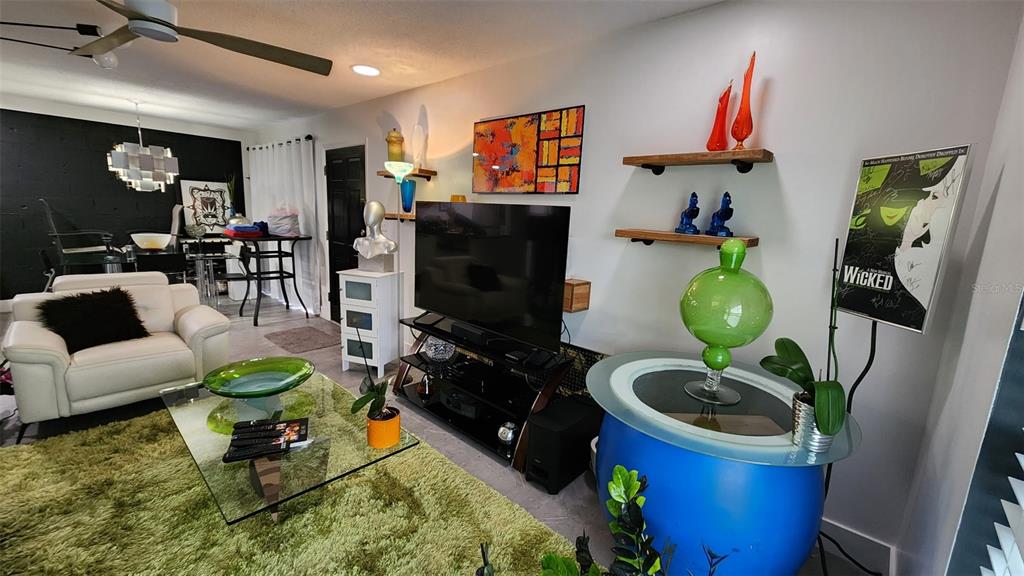 1935 South Conway Road, Unit T6 Orlando, FL 32812 - Photo 11 of 33 a living room with furniture a flat screen tv and a fireplace