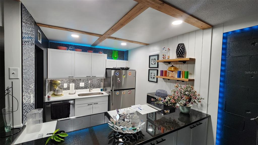 1935 South Conway Road, Unit T6 Orlando, FL 32812 - Photo 22 of 33 a kitchen with refrigerator and cabinets