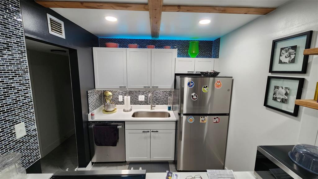 1935 South Conway Road, Unit T6 Orlando, FL 32812 - Photo 23 of 33 a kitchen with stainless steel appliances granite countertop a refrigerator and a sink