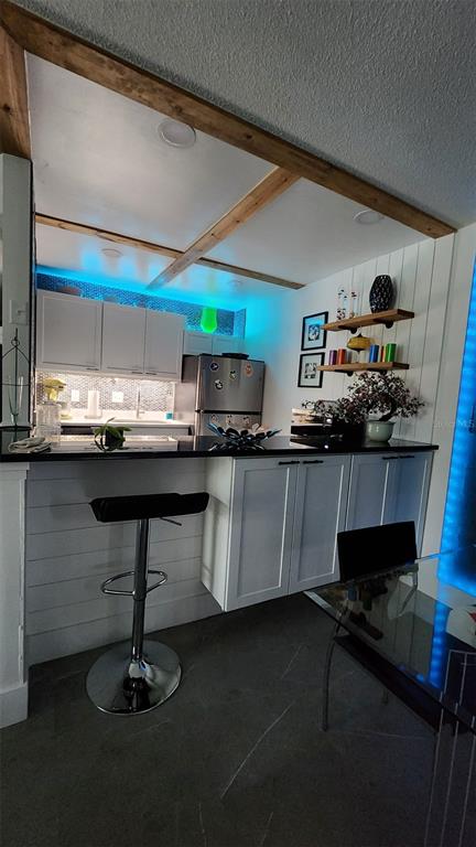 1935 South Conway Road, Unit T6 Orlando, FL 32812 - Photo 25 of 33 a kitchen with kitchen island granite countertop a sink cabinets and window