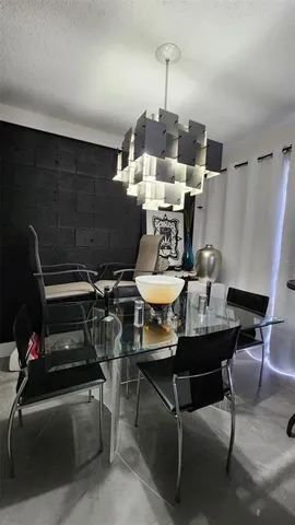 a living room with furniture a rug and a chandelier